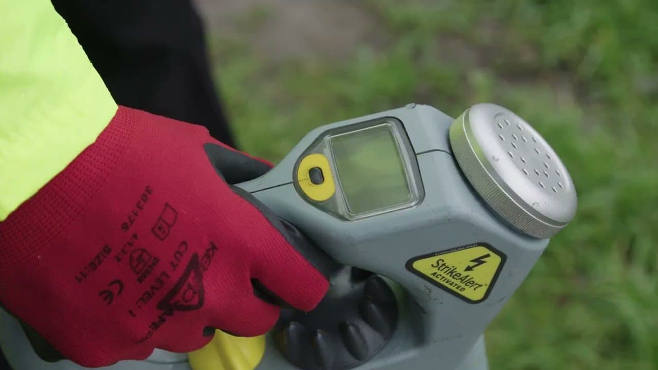 A gloved hand on the controls of a Genny